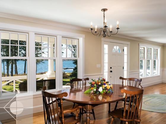 Dining area and great room, both with waterfront views.