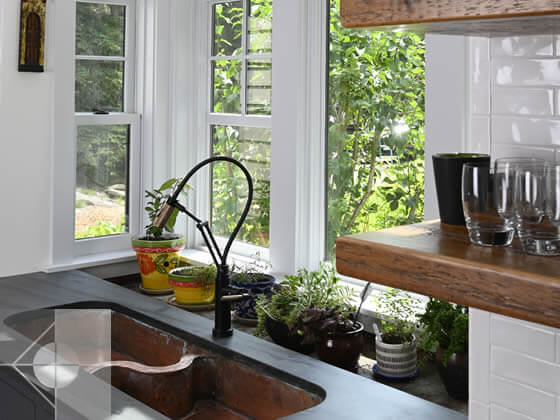 Custom sink with inset area for plants behhind the sink.