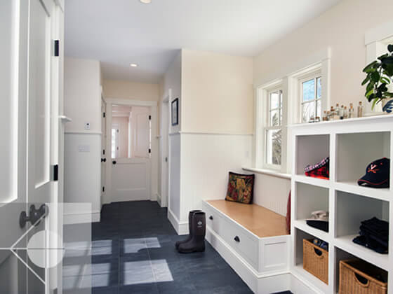 Entry way and mudroom with built in areas for shoes and hats.