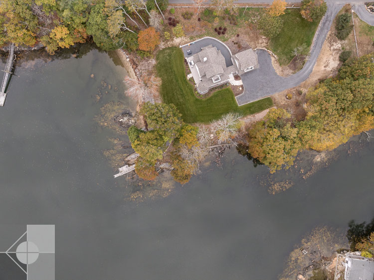 View of Boothbay Harbor home featuring garage and wrap around porch.