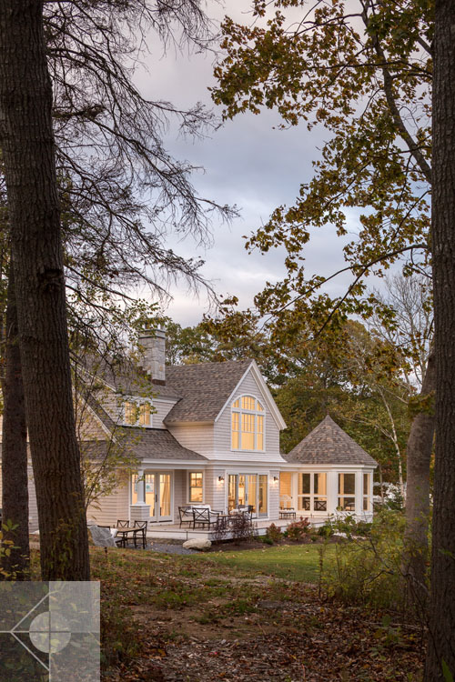 View of Boothbay Harbor home featuring garage and wrap around porch.