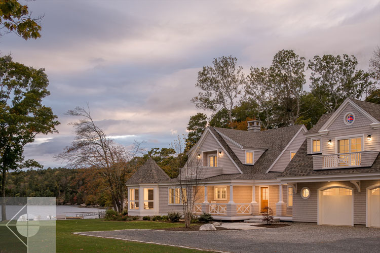 View of Boothbay Harbor home featuring garage and wrap around porch.