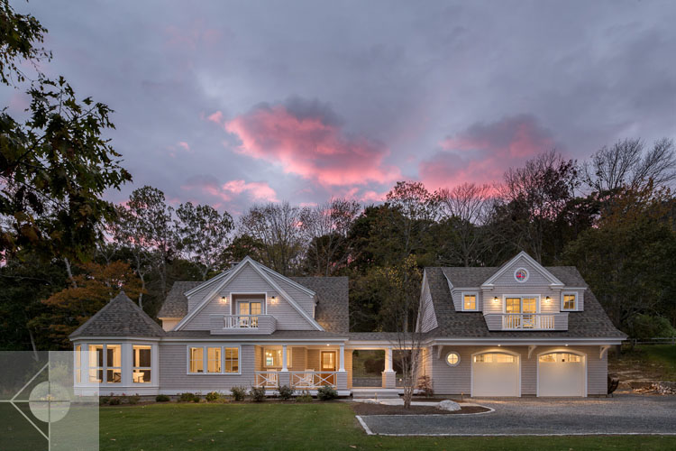 View of Boothbay Harbor home featuring garage and wrap around porch.