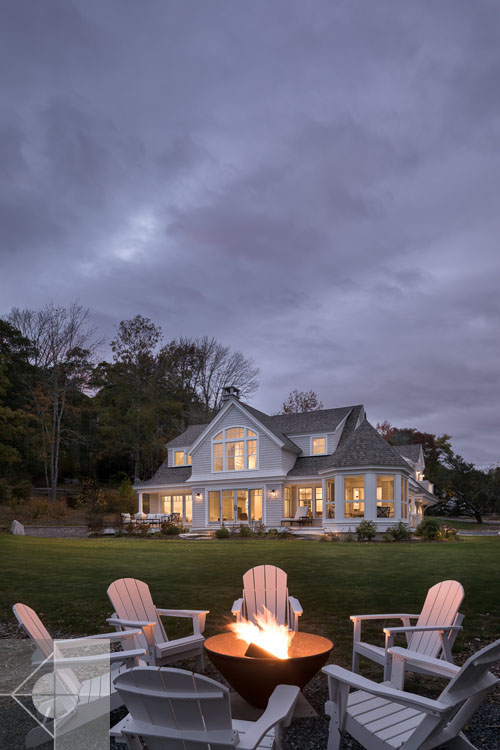 View of Boothbay Harbor home featuring garage and wrap around porch.