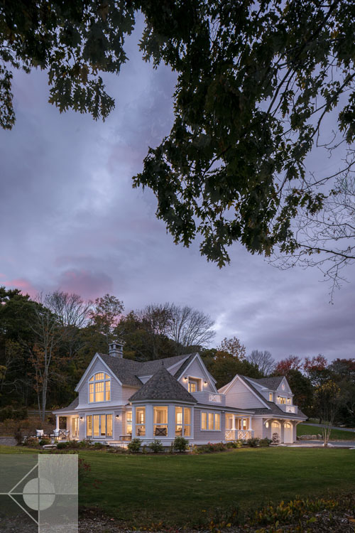 View of Boothbay Harbor home featuring garage and wrap around porch.