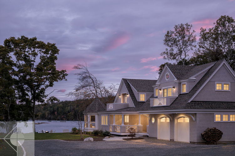 View of Boothbay Harbor home featuring garage and wrap around porch.