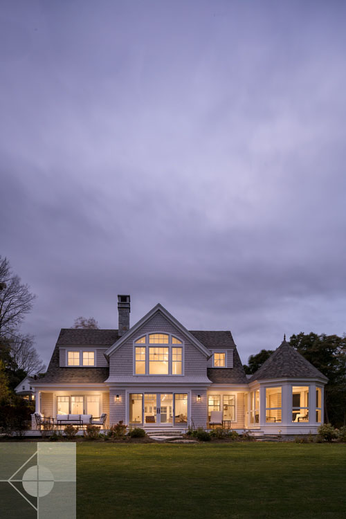 View of Boothbay Harbor home featuring garage and wrap around porch.