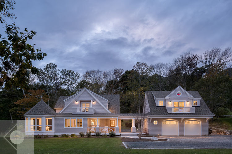 View of Boothbay Harbor home featuring garage and wrap around porch.