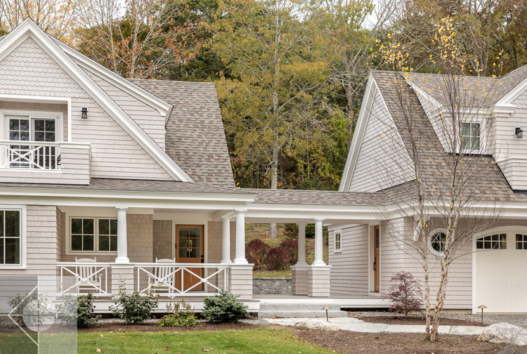 View of Boothbay Harbor home featuring garage and wrap around porch.