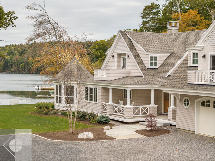 View of Boothbay Harbor home featuring garage and wrap around porch.