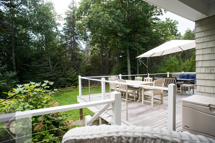 Deck with dining area, umbrella and grill.