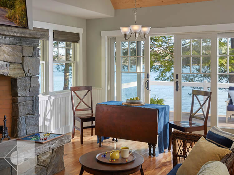 Dining area of cottage in Edgecomb, Maine by Phelps Architects