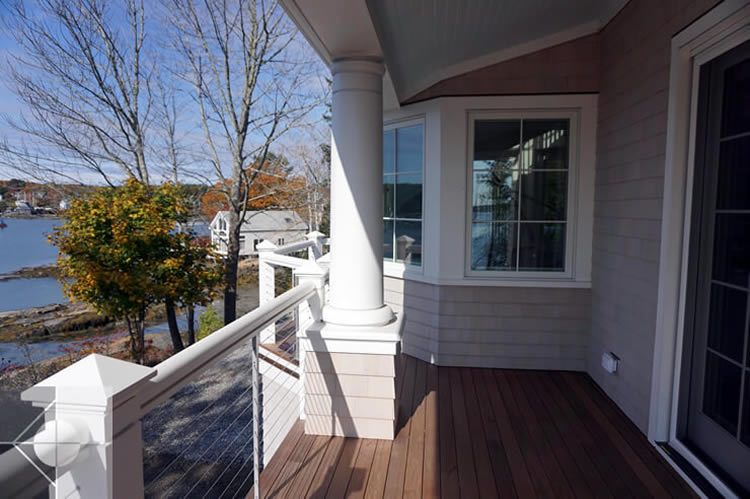Link to a porch image of the Round Pond Harbor home designed by Phelps Architects.