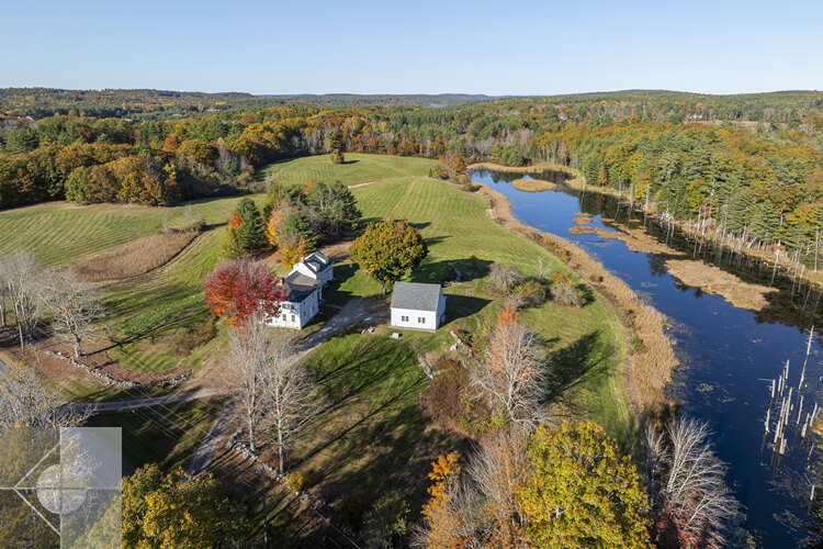 Aerial view of the Newcastle home and garage and surrounding farms and forests.