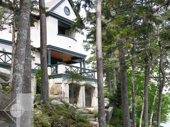 Exterior landscape design featuring stone archways in a Southwest Harbor, Maine house.