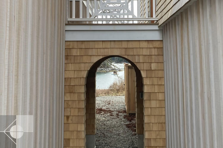 Arched walkway to the water with second story walkway.
