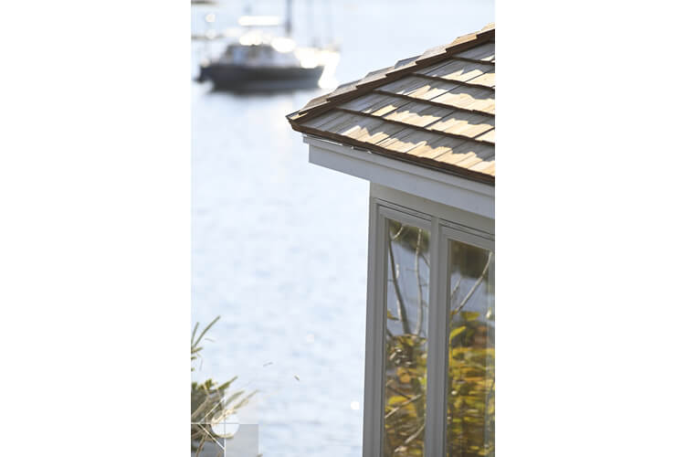 Link to an exterior image of the Round Pond Harbor home designed by Phelps Architects.