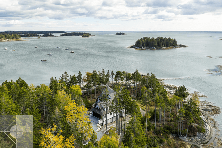 Aerial view of home with ocean and island in the background.