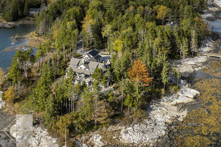 St. George, Maine home with water on three sides, featuring natural rock at the property edge.